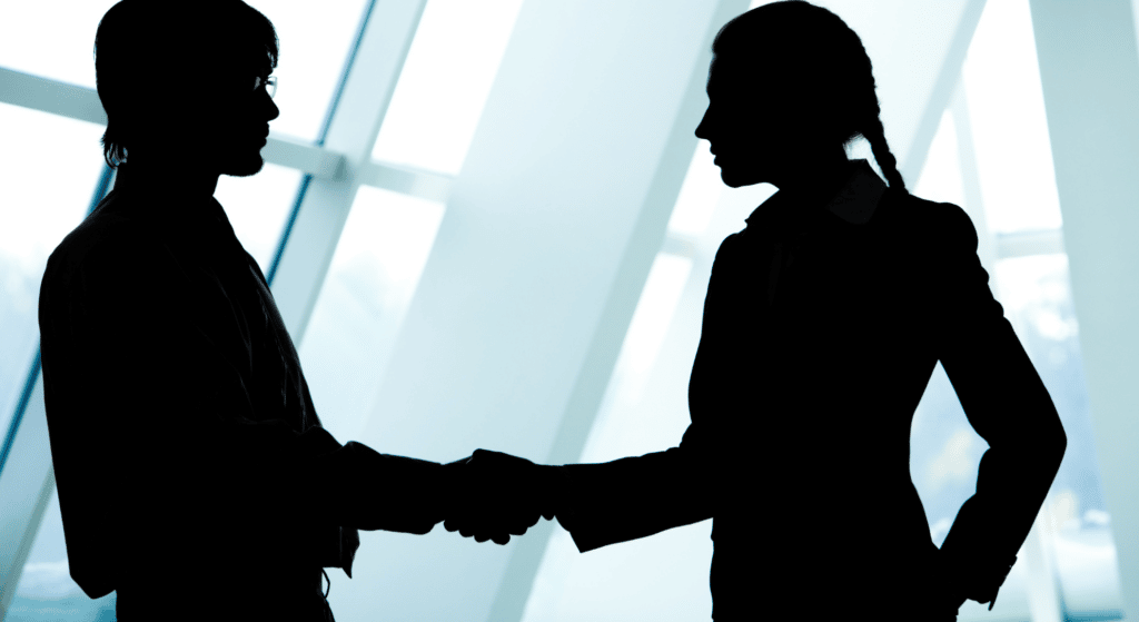 Binding Financial Agreement WA (Pre-Nuptial) Two people shaking hands in dark