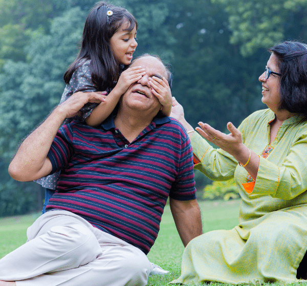 Grandparents playing with child in a park